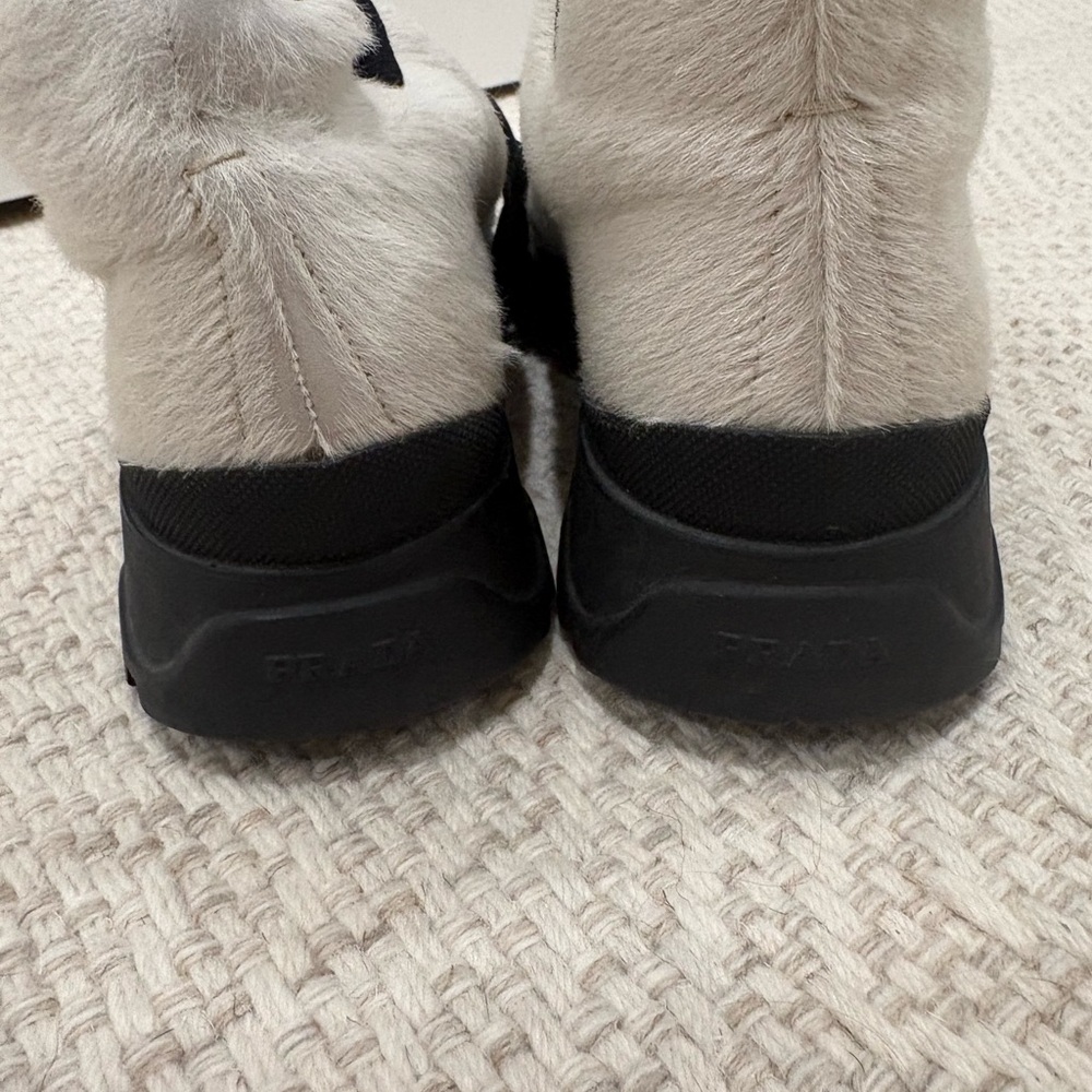 F/W 1998 Prada Sport white pony hair shoes with a black chunky rubber lug sole.
